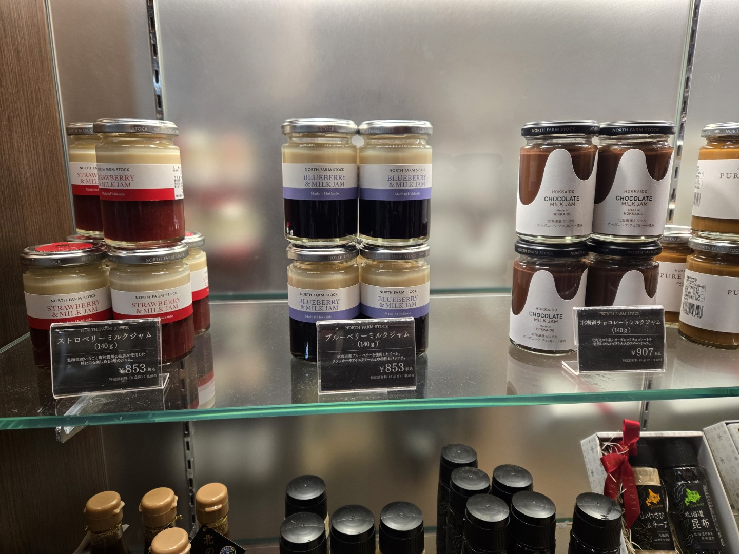 A photo of a book depicting a white snow fox with red cheeks and red-tipped ears. It looks like a Pikachu if it were drawn using only red and white ink!